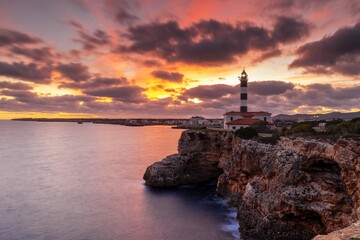 view of the Portocolom Lighthouse in eastern Mallorca at sunset