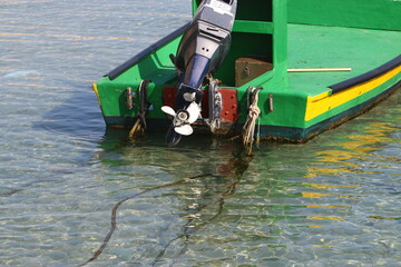 The propeller of a motor boat at the pier in the seaport.