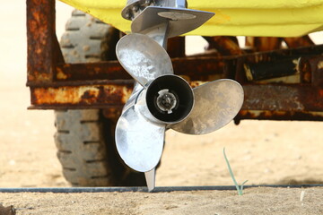 The propeller of a motor boat at the pier in the seaport.
