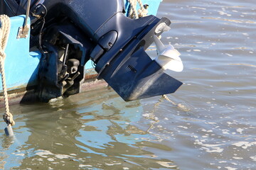 The propeller of a motor boat at the pier in the seaport.