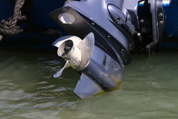 The propeller of a motor boat at the pier in the seaport.