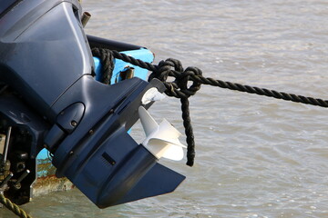 The propeller of a motor boat at the pier in the seaport.