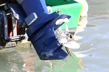 The propeller of a motor boat at the pier in the seaport.