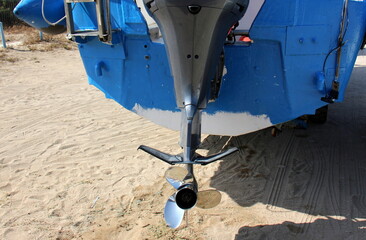 The propeller of a motor boat at the pier in the seaport.
