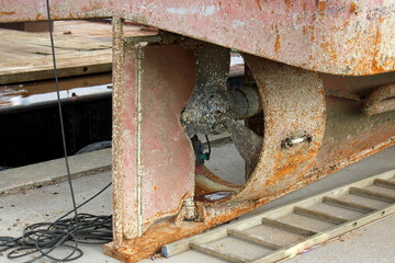 The propeller of a motor boat at the pier in the seaport.