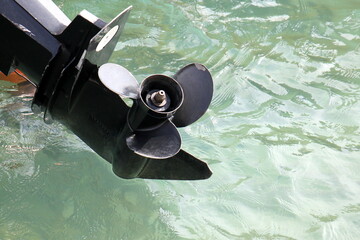 The propeller of a motor boat at the pier in the seaport.
