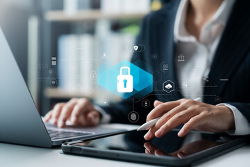 Businesswoman taps a lock icon to safeguard personal information on a tablet. Securing cybersecurity, conducting online transactions, syncing and storing crucial data.