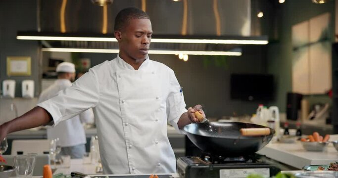Add, black man or chef and pan on fire in kitchen for cooking with speed, professional and enhance flavor or taste. Person, serious and roast with flame for frying, gastronomy and culinary techniques