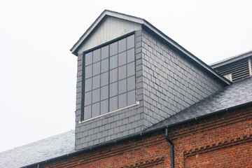 Gable Window on A Shingle-Clad Brick Building