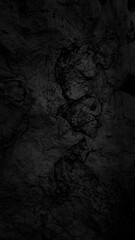 Empty black stone cave wall for abstract  background and texture. beautiful patterns, space for work, banner, wallpaper close up.Vertical.