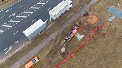 Drone photography of construction workers, industrial machinery laying new pipeline near a road...