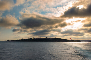 Silhouette of Istanbul at sunset with dramatic clouds view from a ferry