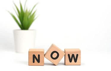 NOW message of wooden blocks with letters on white background. Now made with building blocks....