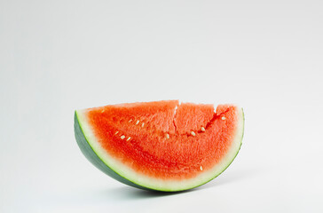 A juicy, red, freshly cut slice of watermelon with hardly any seeds