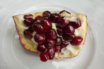 Ripe pomegranate fruit segment isolated on white background
