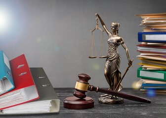 Wooden hammer on the judge table with documents