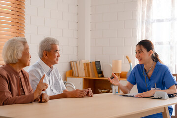 Happy Senior Asian Woman Receives Medical Care at Home, Doctor or Caregiver Nurse Provide Support...