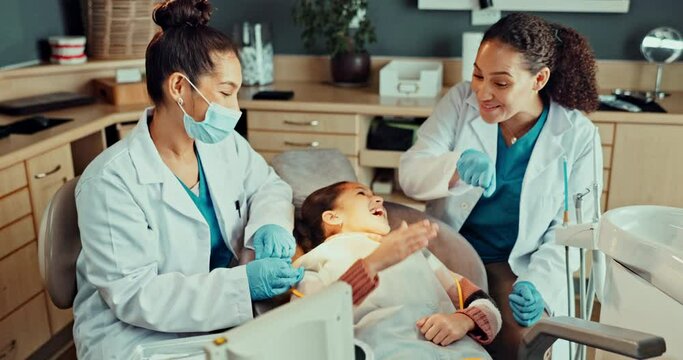 Dental hygienist, dentist and child with fist bump after cleaning consultation and dental care service. Happy, success and kid patient with a smile for health consulting with help and advice