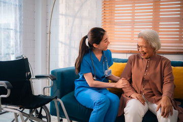 Happy Senior Asian Woman Receives Medical Care at Home, Doctor or Caregiver Nurse Provide Support...