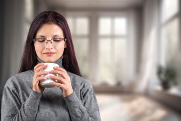 Beautiful young happy  woman relaxing drinking hot tea