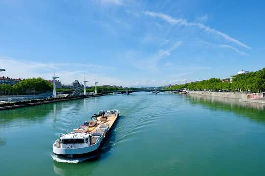 Barge on the Rh&ocirc;ne river in Lyon, France. on the left the Tony Bertrand Nautical Centre.