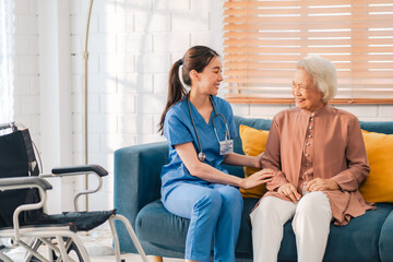 Fototapeta premium Happy Senior Asian Woman Receives Medical Care at Home, Doctor or Caregiver Nurse Provide Support Assistance, Enhancing Healthcare Services for Elderly Patients Retirement