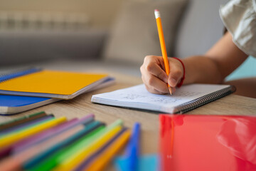 Close-Up Of A Primary School Girl Hand Doing Homework. Homeschooling. Summer School. Real Elementary Student. Back To School.