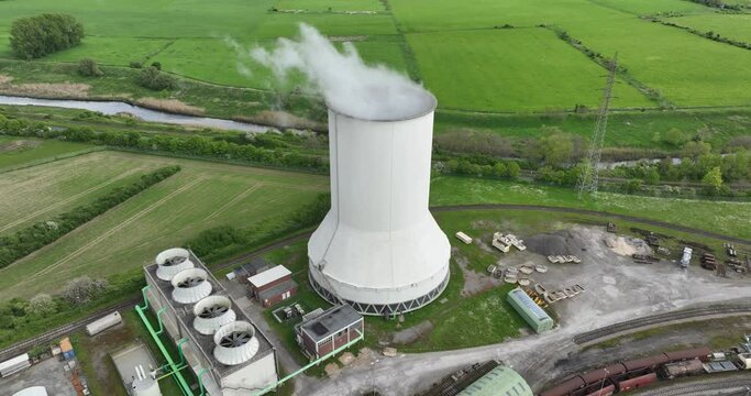 Aerial drone view of a smoking smokestack at a chemical park in Rheinberg, North Rhine Westphalia, Germany.