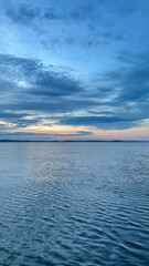 Serene Evening at Ladoga Lake with Calm Waters and Dramatic Sky. Vertical Shoot 