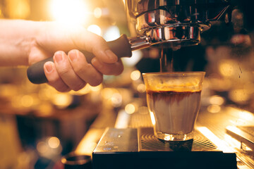 Professional Barista Prepares Fresh Cappuccino in a Busy Cafe: Closeup of Hands Skillfully Using...