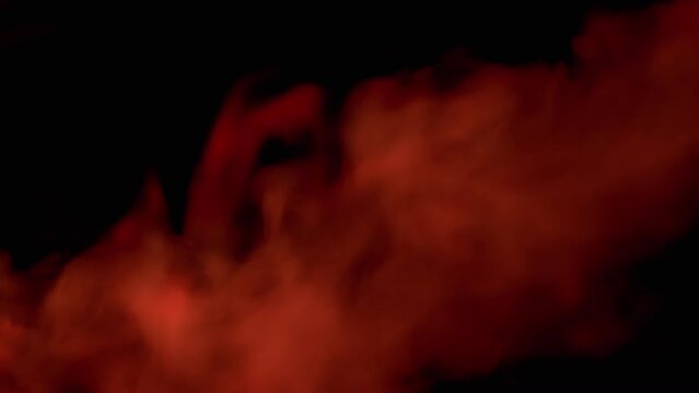 Explosion of Red Smoke or Vapor on Black Blurred Background. Abstract. Side view. Flash. Soft puffs of smoke or steam mix chaotically on empty space. Flash. Passing smoke, tail. Particle explosion.
