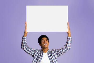 Advertisement. Student holding blank banner with copy space for your text, pink background