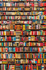 Large amount of books are stacked on bookshelf in library.