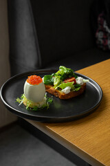Caviar egg with toast and salad