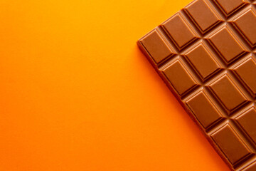 Dark chocolate isolated on yellow background