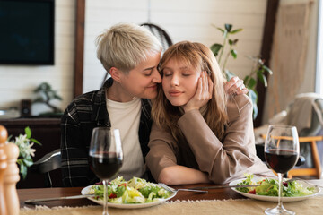 Lesbian love and care concept. LGBT transgender female couple hugging embracing on romantic date...