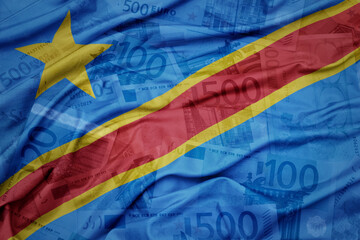 waving colorful national flag of democratic republic of the congo on a euro money banknotes background. finance concept.