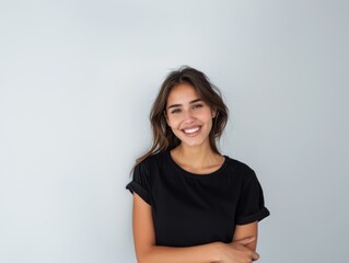 Beautiful natural brunette woman, smiling and looking in camera with white teeth. Close-up portrait of cute female woman in black t-shirt on white background. 