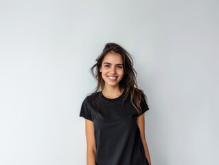 Beautiful natural brunette woman, smiling and looking in camera with white teeth. Close-up portrait of cute female woman in black t-shirt on white background. 