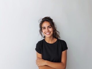 Beautiful natural brunette woman, smiling and looking in camera with white teeth. Close-up portrait of cute female woman in black t-shirt on white background. 