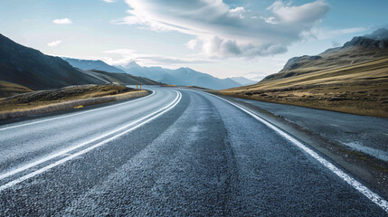 Naklejka premium Winding Mountain Road. Scenic view of a winding asphalt road through a majestic mountain landscape.