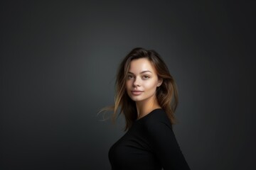 Fototapeta premium Portrait of an attractive woman on a gray background. Female beauty.