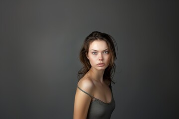 Fototapeta premium Portrait of an attractive woman on a gray background. Female beauty.