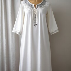 white dress with Slavic patterns on the collar