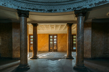 Entrance hall with columns in old abandoned mansion