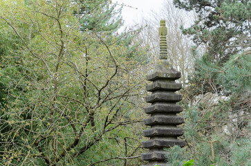 Japanese style stone tower in the middle of the forest.
