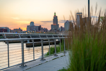 Stainless steel railing along a public exterior wooden board walk in an urban setting.