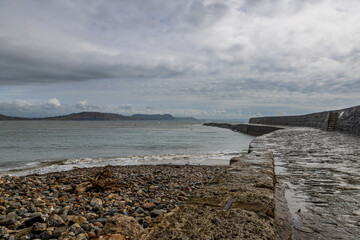 A pathway alongside a harbour wall, at Lyme Regis in Dorset