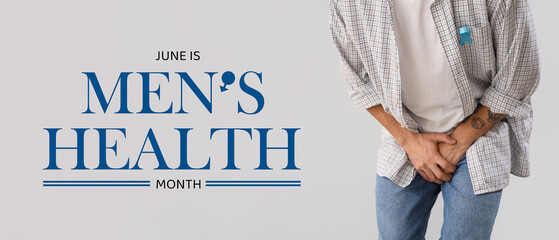 Young man with blue ribbon on light background, closeup. Prostate cancer awareness concept