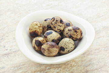 Raw quail eggs heap in the bowl